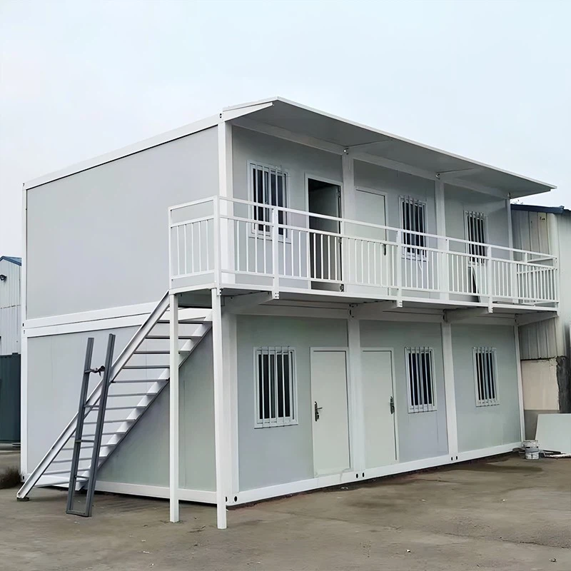 This is a double-storey simple prefabricated house with a staircase on the left side and a walkway board and canopy on the second floor, which is mainly used as a dormitory for civilian workers more